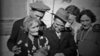1933: Extended family petting family car outside of depression era home. DENVER, COLORADO
