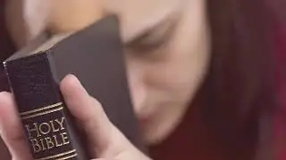 Video background   Woman praying with the holy bible video loop 1080p Full HD