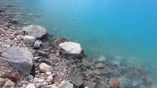 Calm Water Rippling Over Rocks