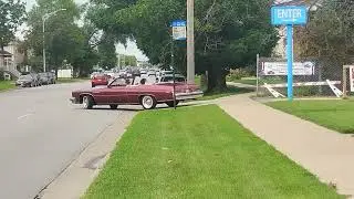 A 1975 Buick LeSabre Convertible is leaving the American Legion Car and Bike Show.