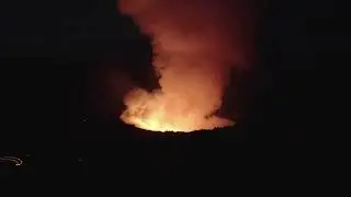 VideoVault Stock Video: Large volcano with bubbling lava and emitting steam
