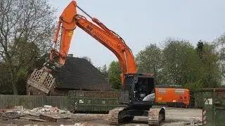 Follow this skilled operator in his Hitachi Zaxis 350 crawler excavator tearing down a car workshop