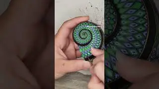 Painting the spiral on a snail shell with snakes and roses #paintedshell #shellpainting #mandalaart