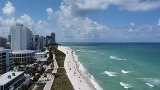 Drone view and drive through amazing Collins Avenue in Miami Beach, Florida.