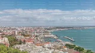 Panorama showing aerial view of marina and city center timelapse in Setubal, Portugal.
