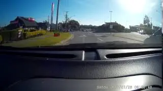 white ute overtakes blue camry at roundabout