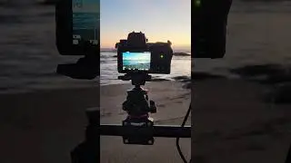 Behind scenes of recording audio and video of ocean waves in twilight colors