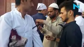 People tie black bands in protest against lynching of Muslims