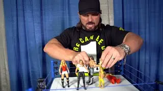 Эй Джей Стайлз рассматривает первую фигурку Ронды Раузи в WWE