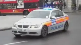 Metropolitan Police cars and vans responding with lights and sirens