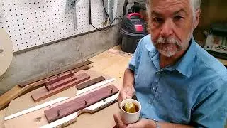 A jig for contouring a bridge to fit a spherical top