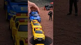 safety car falling into a hole, pushed by blue subaru rally car