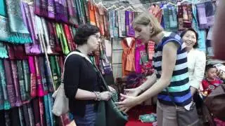 Ambassador Bitter learning about Lao silk and having her first Lao skirt made