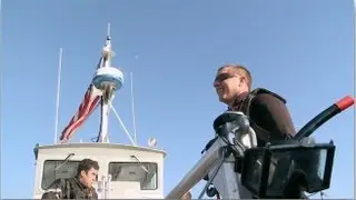 An Air Rescue Swimmer Jumps out of a Helicopter