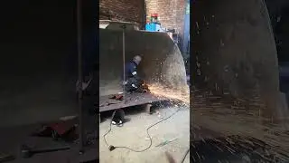 USING GRINDING WHEEL TO REMOVE EXCESSIVE MIG WELD AFTER CATERPILLAR'S BUCKET REPAIR