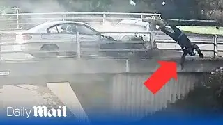 Horrifying moment biker is catapulted over the side of a bridge after being hit by road rage driver