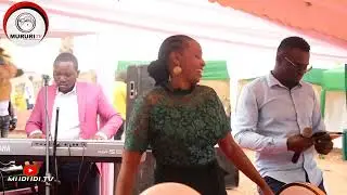 JOHN PRAISE, JOSPHAT MACHARIA AND TEACHER BEATRICE KUINA RWIMBO RWA MAGEGANIA..