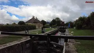 Bath England: Boat navigating thru canal locks with different water l&egrave;vels at Kennet and Avon Canal.