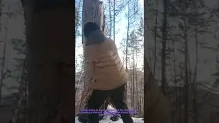 Chopping a Massive Tree Stump in a Snowy Forest