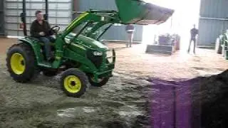 Three John Deere Compact Tractors in action