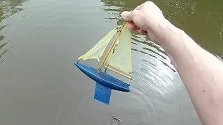 Trying the little blue toy sailing boat in the duck pond at Portishead