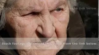 Portrait of old talking woman . Serious grandmother sitting outdoor and speaking. Close-up