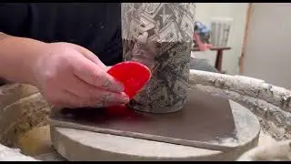 Applying a transfer on the pottery wheel