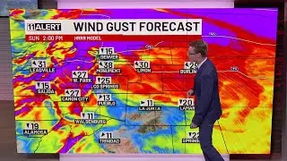 Snow tapering off, still cold and breezy Sunday