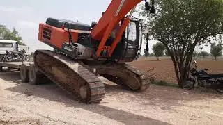 unloading of jcb excavator from truck