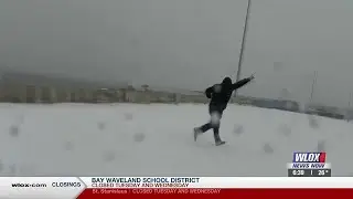 Kids play on snow-covered Popp's Ferry Bridge