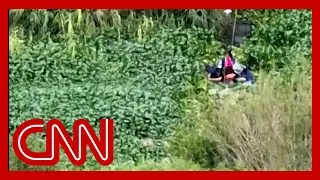 US border officials watch migrants use rafts to cross into US