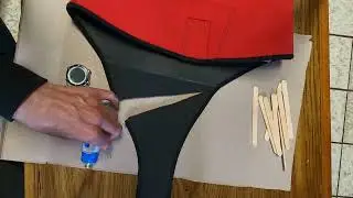 Repairing a rip in a wetsuit using wetsuit glue.
