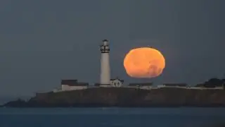 Full moonset behind the Pigeon Point Lighthouse on a turbulent morning