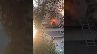 Firefighters rescue their own as he falls through the roof of a burning house.