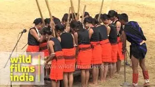 Lotha tribe demonstrate traditional way of pounding rice, Nagaland