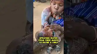 Spraying water from their mouth to bathe a child #africanwoman #namibianwoman #bathing #shortsviral