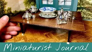 A table in ebony, silver and walnut.