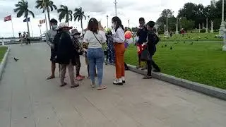 Two Girls give some food to Poor People