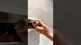 Applying fresh plaster smoothly to repair and level the wall surface for a clean finish