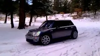 mini cooper s hits rock in snow