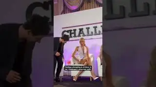 Zendaya attempting to sit down in her'Challengers' press tour outfit.