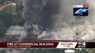 Fire burning at business pours thick, black smoke into air