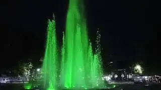The fountain of lights at night changing its colors. 