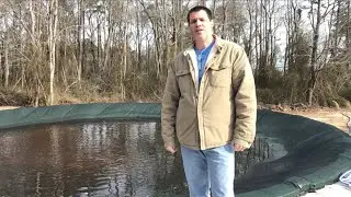 Pool cover fighting wind and rain.