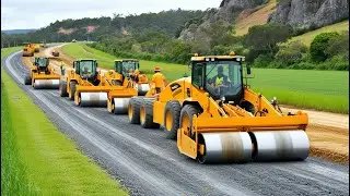Road construction featuring several large yellow construction machinery, working on a gravel road