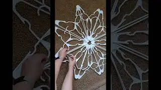 Making easy snow flakes with hangers .