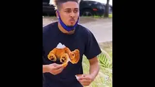 Dipping chicken nuggets  in sauce on top of strangers head