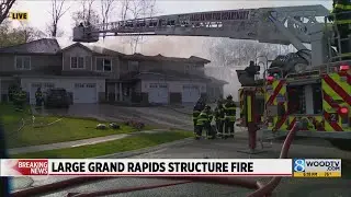 Firefighters work to put out flames at multiplex in Grand Rapids