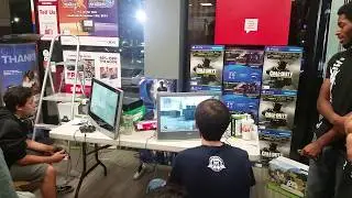 GameStop manager tries out Call Of Duty: Modern Warfare Remastered.