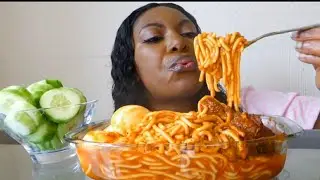 Nigerian/African food Mukbang spicy juicy noodles with eggs , chicken and cucumber.